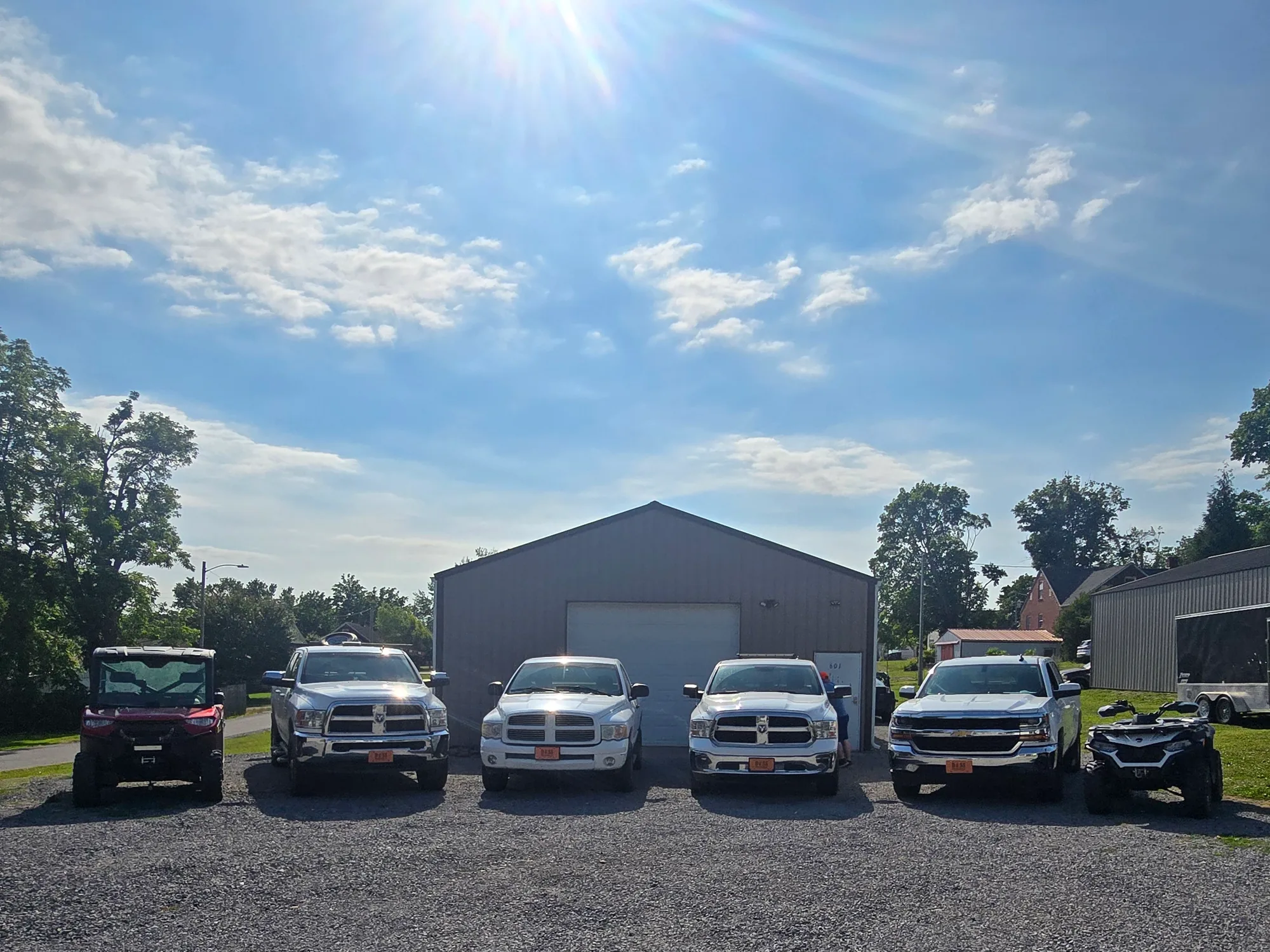 The Doss Land Surveying office in Lafayette, Tennessee with the firm's field trucks lined up outside on a clear morning.